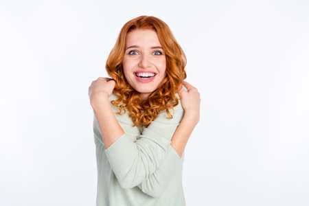 Photo portrait of red haired girl cute overjoyed embracing herself laughing isolated white color...