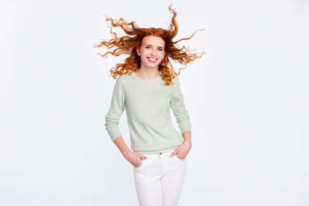 Photo portrait of young woman smiling confident in casual clothes with flying hair isolated white...