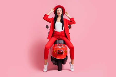 Full body photo of young attractive girl pouted lips send air kiss wear sunhat sit bike summer trip isolated over pastel color backgroundの写真素材