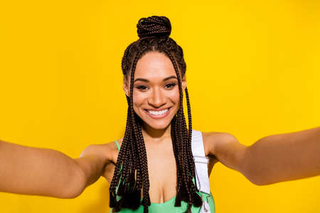 Photo of positive charming nice happy afro american woman make selfie smile isolated on yellow color...