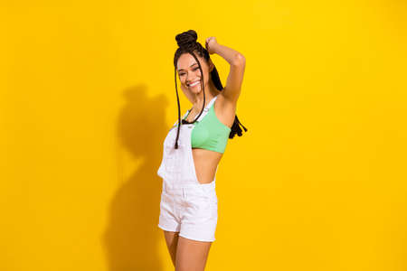 Photo of dreamy sweet dark skin lady wear green crop top smiling dancing isolated yellow color backgroundの写真素材