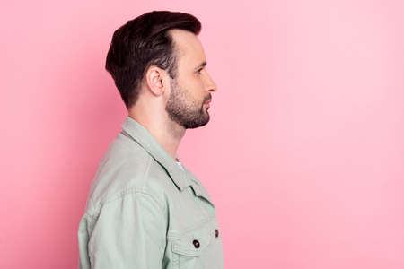 Profile side view portrait of attractive content serious brunet guy copy space isolated over pink...