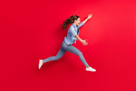 Full length body size side profile photo of cheerful girl jumping up running catching isolated...