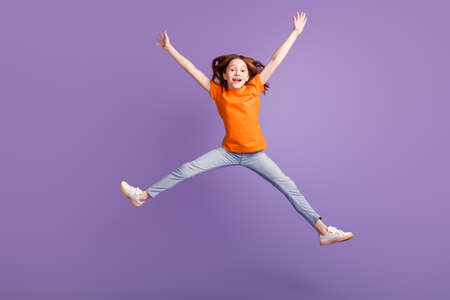 Full length body size view of attractive girlish cheerful girl jumping fooling having fun isolated over violet purple color backgroundの写真素材