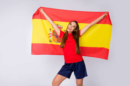 Photo of cheerful lady joy fun support soccer team league 2020 uefa euro play off game carry spain national flag wear spanish football uniform t-shirt shorts isolated white color backgroundの写真素材