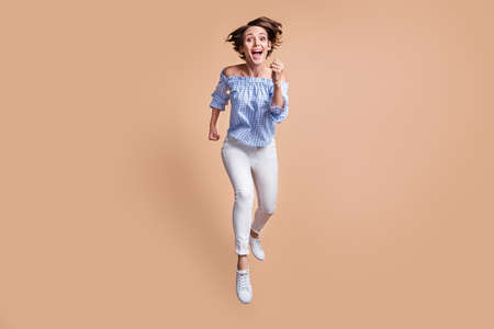 Photo portrait of crazy screaming woman running forward at camera jumping up isolated on pastel...