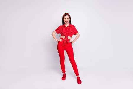 Photo of charming young girl hands hips wear red dotted blouse pants footwear isolated grey color...