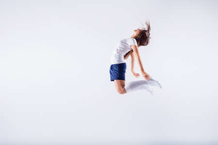 Full length body size view of nice attractive lovely slim thin sportive devoted straight-haired girl jumping having fun 2020 final contest isolated on light white gray pastel color backgroundの写真素材