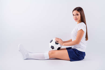 Profile side view portrait of her she nice attractive lovely pretty content straight-haired girl sitting with ball world supporter isolated on light white gray pastel color backgroundの写真素材