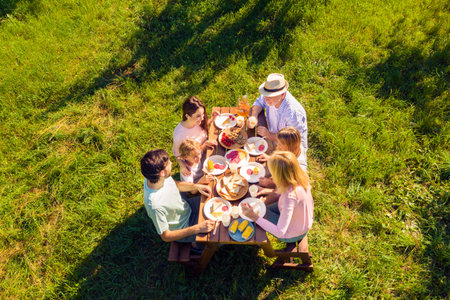 High above angle view big full family having picnic outdoors cheerful on holidays spending time togetherの写真素材
