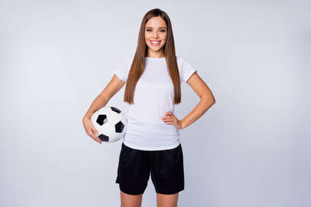 Photo of sporty shapes lady skilled player soccer women team hold leather ball toothy smiling good mood wear football uniform t-shirt shorts isolated white color backgroundの写真素材