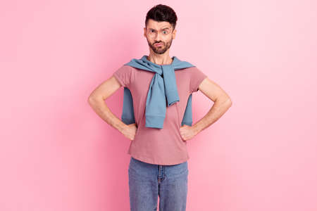 Photo unhappy irritated man hold fists waist wear glasses bad mood isolated on pastel pink color backgroundの写真素材