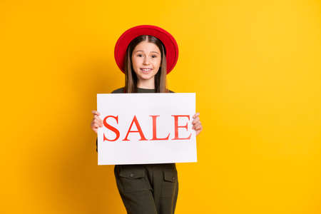 Photo portrait of lovely girl keeping sale carton on black friday isolated vibrant yellow color...