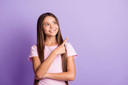 Photo of young girl happy smile indicate finger empty space ad promo advice choose decision isolated...