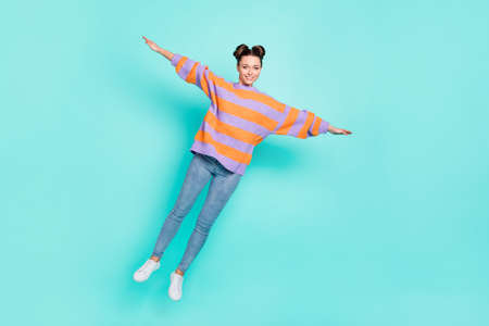 Full length body size view of pretty trendy cheerful girl jumping balance like plane isolated over...