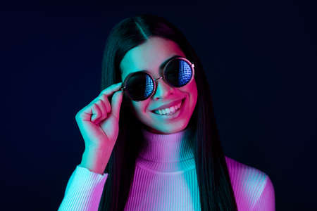 Photo of sweet young lady hand eyewear wear white sweater isolated on black dark color background