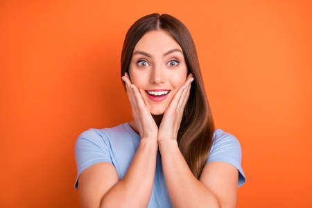 Photo of impressed brown hairdo millennial lady hands face wear blue t-shirt isolated on vivid...