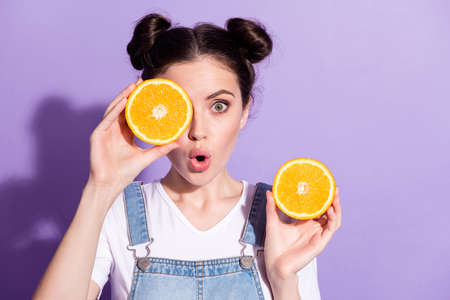 Photo of cute impressed young lady wear jeans overall orange half piece close eye isolated violet color backgroundの写真素材