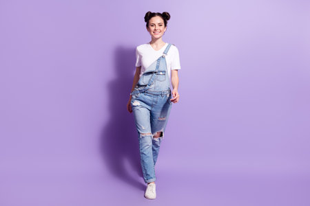 Full size photo of young attractive girl happy positive smile go walk step isolated over violet color backgroundの写真素材