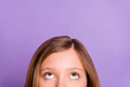 Cropped photo of young little girl look empty space information advert amazed isolated over violet...