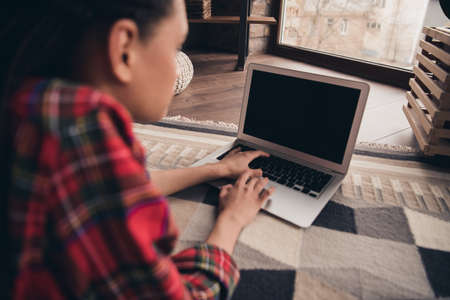 Profile side view portrait of attractive skilled girl lying on floor using laptop writing it...