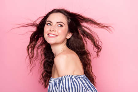 Profile photo of nice optimistic brunette lady look empty space wear blue dress isolated on pink color backgroundの写真素材