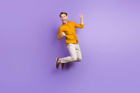 Full length body size photo of businessman jumping up gesturing like winner isolated on vibrant...