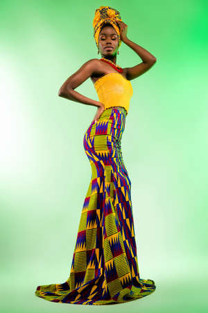 Vertical full length body size view of attractive chic elegant girl wearing dress posing isolated over vivid filter green color backgroundの写真素材