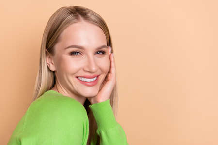 Profile side view portrait of attractive blond cheerful girl touching clean clear skin copy space...