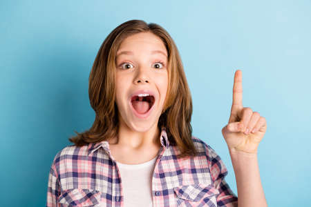 Funny small girl wear the checkered shirt open mouth pointing finger