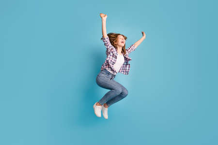 Full size profile of cheerful active pupil raise hands beaming smileの写真素材