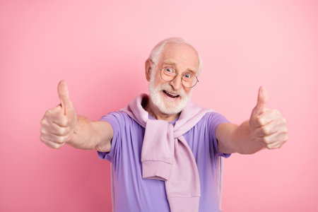 Portrait of elder man cheerful overjoyed showing thumb-up like signの写真素材
