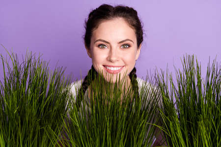 Photo of positive happy nice young woman good mood smile grass green garden isolated on purple color backgroundの写真素材