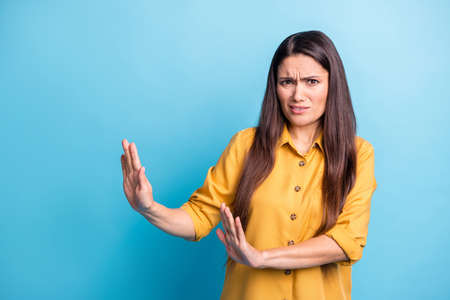 Photo portrait of brunette with long hair in yellow shirt refusing rejecting isolated on vibrant...