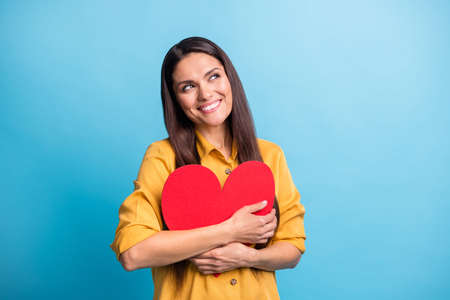 Photo of charming person hands hold hug red heart card look empty space isolated on blue color...