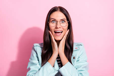 Photo of pretty nice cute amazed young woman hold hands cheekbones good mood isolated on pink color...