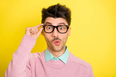 Photo of young handsome serious shocked amazed surprised man in funky glasses isolated on yellow...