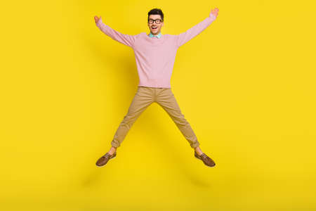 Full size photo of young happy positive excited crazy smiling man jumping in star pose isolated on...