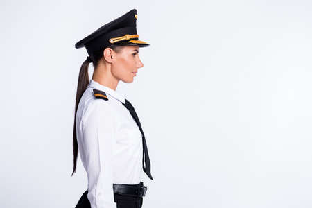 Profile photo of pretty successful lady look empty space wear hat aviator uniform isolated white color backgroundの写真素材