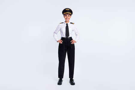 Photo of cheerful charming lady hands hips wear hat aviator uniform pants shoes isolated white color backgroundの写真素材