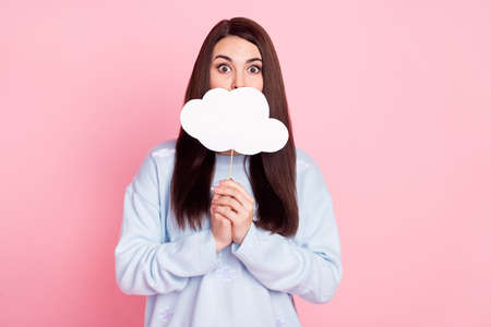 Photo of cute scared young woman wear blue pullover white cloud cover lips empty space isolated pink color backgroundの写真素材