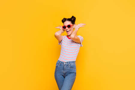 Photo of sweet funny young lady dressed striped outfit dark eyewear dancing arms ears isolated...