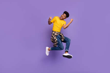 Full length body size view of attractive cheerful successful guy jumping celebrating isolated over...