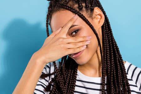 Cropped photo of young black girl happy positive smile look spy playful isolated over blue color...