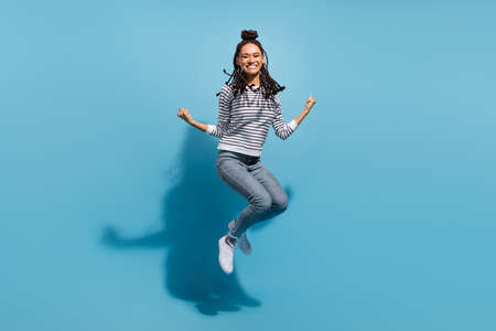 Full body profile side photo of young african girl happy positive smile jump rejoice victory...