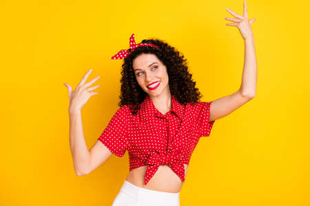 Photo of optimistic nice brunette lady look empty space wear shirt band isolated on yellow color backgroundの写真素材