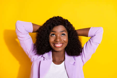 Photo of young happy lovely smiling dreamy afro woman look copyspace relax isolated on yellow color...