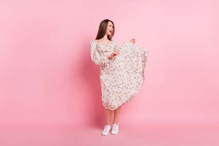 Full length body size photo pretty girl dancing laughing relaxing at party isolated pastel pink color backgroundの写真素材