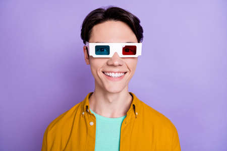 Photo of young man happy positive smile wear 3d glasses cinema watch isolated over violet color backgroundの写真素材
