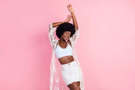 Photo of joyful happy nice afro american woman dance good mood smile weekend isolated on pink color backgroundの写真素材